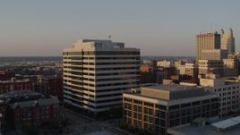 5.7K aerial stock footage of an office building at sunset seen while descending in Downtown Kansas City, Missouri Aerial Stock Footage | DX0001_001353