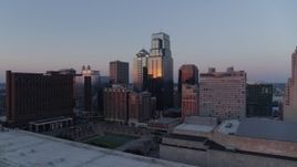 5.7K aerial stock footage flyby skyscrapers near hotel at sunset and hover for static view in Downtown Kansas City, Missouri Aerial Stock Footage | DX0001_001369