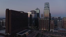 5.7K aerial stock footage of flying away from hotel and skyscrapers at twilight in Downtown Kansas City, Missouri Aerial Stock Footage | DX0001_001380