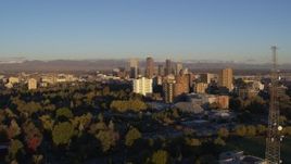 5.7K aerial stock footage flyby radio tower near apartment buildings for view of skyscrapers at sunrise, Downtown Denver, Colorado Aerial Stock Footage | DX0001_001408
