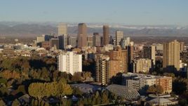 5.7K aerial stock footage of tall skyscrapers in Downtown Denver, Colorado at sunrise, seen while descending near apartment buildings Aerial Stock Footage | DX0001_001417