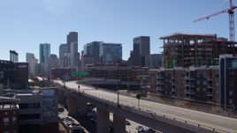 5.7K aerial stock footage of the city skyline while ascending near offramp in Downtown Denver, Colorado Aerial Stock Footage | DX0001_001484