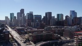 5.7K aerial stock footage of the city skyline seen while descending near offramp in Downtown Denver, Colorado Aerial Stock Footage | DX0001_001485