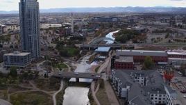 5.7K aerial stock footage of skyscraper, bridges spanning South Platte River, and apartment complex in Downtown Denver, Colorado Aerial Stock Footage | DX0001_001500