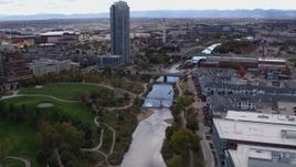 5.7K aerial stock footage fly over South Platte River to approach bridges and skyscraper in Downtown Denver, Colorado Aerial Stock Footage | DX0001_001501