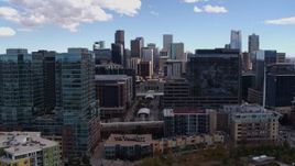 5.7K aerial stock footage descend near office buildings with view of skyline in Downtown Denver, Colorado Aerial Stock Footage | DX0001_001503