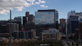 5.7K aerial stock footage of an office building seen while descending to park in Downtown Denver, Colorado Aerial Stock Footage | DX0001_001511