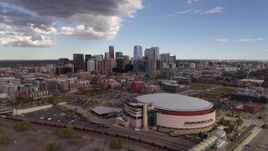 5.7K aerial stock footage of the city skyline seen from while flying by arena, Downtown Denver, Colorado Aerial Stock Footage | DX0001_001534