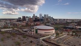 5.7K aerial stock footage of descending near the arena with the city skyline in the background, Downtown Denver, Colorado Aerial Stock Footage | DX0001_001535