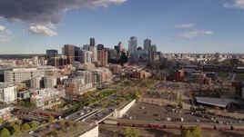 5.7K aerial stock footage flyby the city skyline in the distance, pause for stationary view, Downtown Denver, Colorado Aerial Stock Footage | DX0001_001541