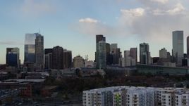 5.7K aerial stock footage of flying by the city skyline with clouds in the sky, Downtown Denver, Colorado Aerial Stock Footage | DX0001_001551