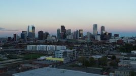 5.7K aerial stock footage of passing by the city's downtown skyline at sunset, Downtown Denver, Colorado Aerial Stock Footage | DX0001_001573