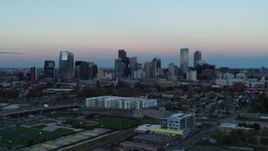 5.7K aerial stock footage of a reverse view of the city's downtown skyline at sunset, Downtown Denver, Colorado Aerial Stock Footage | DX0001_001576