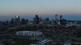 5.7K aerial stock footage flyby the city's downtown skyline at sunset, seen while ascending, Downtown Denver, Colorado Aerial Stock Footage | DX0001_001583