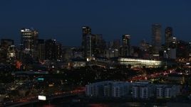 5.7K aerial stock footage reverse view of the city skyline behind the convention center at twilight, Downtown Denver, Colorado Aerial Stock Footage | DX0001_001609