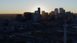 5.7K aerial stock footage of the sun behind the city skyline at sunrise in Downtown Denver, Colorado Aerial Stock Footage | DX0001_001614