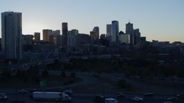 5.7K aerial stock footage descend with view of bright sun and city skyline at sunrise in Downtown Denver, Colorado Aerial Stock Footage | DX0001_001620