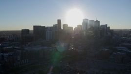 5.7K aerial stock footage of the rising sun behind the city skyline in Downtown Denver, Colorado Aerial Stock Footage | DX0001_001627