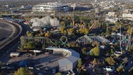 5.7K aerial stock footage reverse view of rides at Elitch Gardens at sunrise in Downtown Denver, Colorado Aerial Stock Footage | DX0001_001635