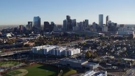 5.7K aerial stock footage ascend to reveal and focus on the city skyline at sunrise in Downtown Denver, Colorado Aerial Stock Footage | DX0001_001642