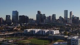 5.7K aerial stock footage ascend to focus on the city's skyline at sunrise in Downtown Denver, Colorado Aerial Stock Footage | DX0001_001646