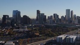 5.7K aerial stock footage of passing by the city's skyline at sunrise in Downtown Denver, Colorado Aerial Stock Footage | DX0001_001648