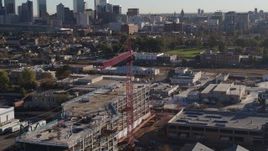 5.7K aerial stock footage circle a crane atop a building under construction at sunrise in Downtown Denver, Colorado Aerial Stock Footage | DX0001_001651