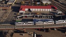 5.7K aerial stock footage track commuter train at sunrise in Downtown Denver, Colorado Aerial Stock Footage | DX0001_001652
