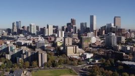 5.7K aerial stock footage static view the city's skyline, before passing office and apartment buildings in Downtown Denver, Colorado Aerial Stock Footage | DX0001_001667
