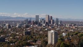 5.7K aerial stock footage of the city's skyline with mountains in the background, seen during ascent, Downtown Denver, Colorado Aerial Stock Footage | DX0001_001723