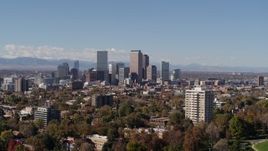 5.7K aerial stock footage ascend to wider view of the city's skyline, seen from park with trees, Downtown Denver, Colorado Aerial Stock Footage | DX0001_001732