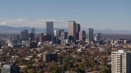 5.7K aerial stock footage slow ascent by the city's skyline with mountains in background, Downtown Denver, Colorado Aerial Stock Footage | DX0001_001741