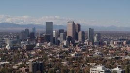 5.7K aerial stock footage slow ascent by the city's skyline with mountains in distance, Downtown Denver, Colorado Aerial Stock Footage | DX0001_001742