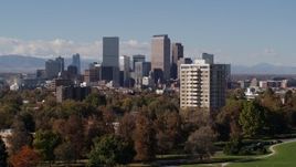 5.7K aerial stock footage ascend while focusing on the city's skyline with mountains in distance, Downtown Denver, Colorado Aerial Stock Footage | DX0001_001744