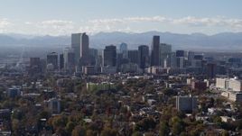 5.7K aerial stock footage of flying by the city's skyline with Rockies in the background during ascent, Downtown Denver, Colorado Aerial Stock Footage | DX0001_001755