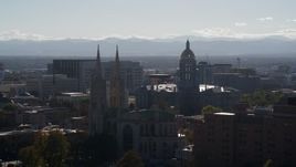 5.7K aerial stock footage of the Colorado State Capitol seen while passing cathedral, Downtown Denver, Colorado Aerial Stock Footage | DX0001_001757