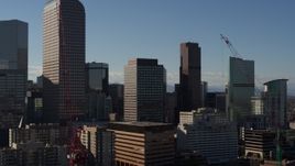 5.7K aerial stock footage passing by Wells Fargo Center and nearby skyscrapers during descent in Downtown Denver, Colorado Aerial Stock Footage | DX0001_001774
