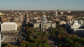 5.7K aerial stock footage fly away from the Colorado State Capitol and tree-lined park, then descend in Downtown Denver, Colorado Aerial Stock Footage | DX0001_001790