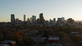 5.7K aerial stock footage of a stationary view before flying by the city skyline at sunset, Downtown Denver, Colorado Aerial Stock Footage | DX0001_001822