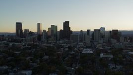 5.7K aerial stock footage fly away from the city skyline at sunset while descending, Downtown Denver, Colorado Aerial Stock Footage | DX0001_001827