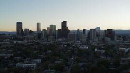 5.7K aerial stock footage of the city skyline at sunset while descending and flying away, Downtown Denver, Colorado Aerial Stock Footage | DX0001_001833
