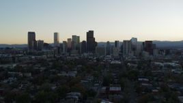 5.7K aerial stock footage of the city skyline at sunset while flying away and descending, Downtown Denver, Colorado Aerial Stock Footage | DX0001_001834