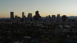 5.7K aerial stock footage of flying by the city's skyline at sunset and ascending in Downtown Denver, Colorado Aerial Stock Footage | DX0001_001846
