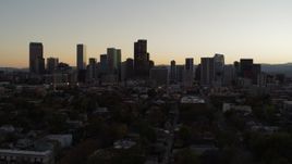 5.7K aerial stock footage slow descent while flying away from the city's skyline at sunset, Downtown Denver, Colorado Aerial Stock Footage | DX0001_001852
