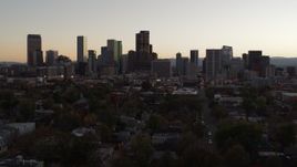 5.7K aerial stock footage of flying by and away from the city's skyline at sunset, Downtown Denver, Colorado Aerial Stock Footage | DX0001_001856