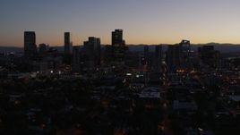 5.7K aerial stock footage of passing and then approaching the city's skyline at twilight, Downtown Denver, Colorado Aerial Stock Footage | DX0001_001873