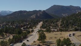 5.7K aerial stock footage of a road through the town of Estes Park, Colorado near mountains Aerial Stock Footage | DX0001_001974