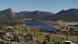 5.7K aerial stock footage of Lake Estes by golf course and green mountains in Estes Park, Colorado Aerial Stock Footage | DX0001_001978
