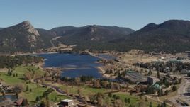 5.7K aerial stock footage of flying by Lake Estes by golf course and green mountains in Estes Park, Colorado Aerial Stock Footage | DX0001_001979
