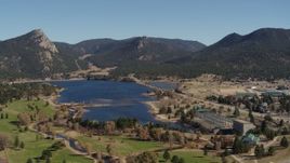 5.7K aerial stock footage slow approach and flyby of Lake Estes, by golf course and green mountains in Estes Park, Colorado Aerial Stock Footage | DX0001_001980